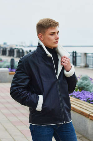 A guy in a warm leather jacket on the embankment. Blagoveshchensk, Russia.の写真素材