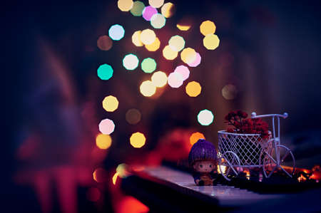 New Year's composition on a musical synthesizer. Toy bike and gnome figurine. Dried rowan branch and...