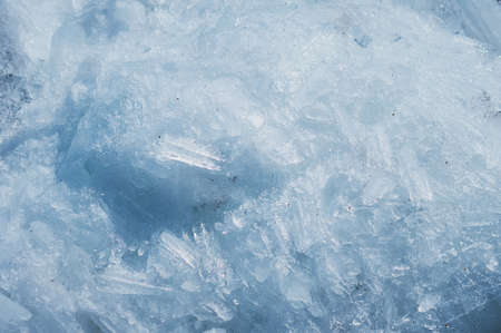 Ice structure of river hummocks in spring. Sharp ice needles on the banks of the Amur River. Blocks...