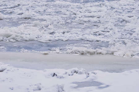 Snow-covered ice on the river during a snowfall. Winter texture. Suga and ice floes.の写真素材