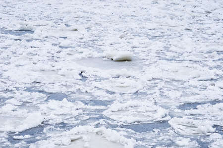 Ice structure on the river. Surface under a layer of snow. Fragments of ice floes were frozen again.の写真素材