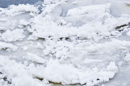 Ice structure on the river. Surface under a layer of snow. Fragments of ice floes were frozen again.の写真素材