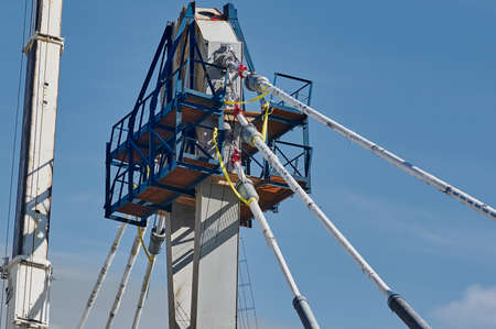 A pylon of a modern cable-stayed bridge with an upper holder for cables and platforms. Construction...