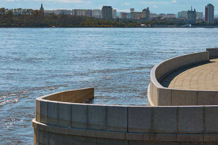 Descent to the Amur River from the granite embankment of Blagoveshchensk, Russia during a flood. View of Heihe city, China.の写真素材