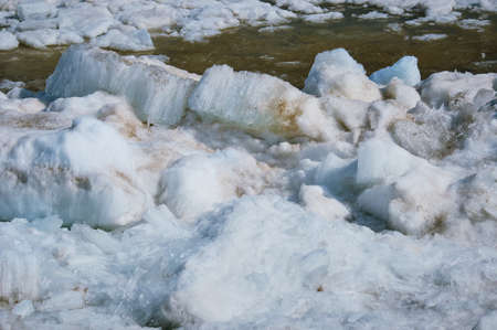 Melting ice on the river in spring. Ice drift time. Natural structure. Needles in the sun.の写真素材