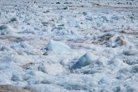 Melting ice on the river in spring. Ice drift time. Natural structure. Needles in the sun.の写真素材