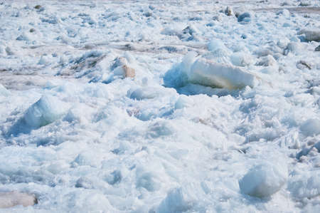 Melting river ice. Columnar and needle-like structure of crystals. Ice floe in the spring on the banks of the Amur River. Close view. Large blocks of solid water. Selective focus.の写真素材