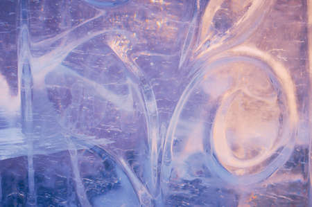 Fragment of an ice figure in the rays of the sun. Christmas natural pattern. Focus inside the material. Refraction, reflection and optical distortion. selective focus.の写真素材