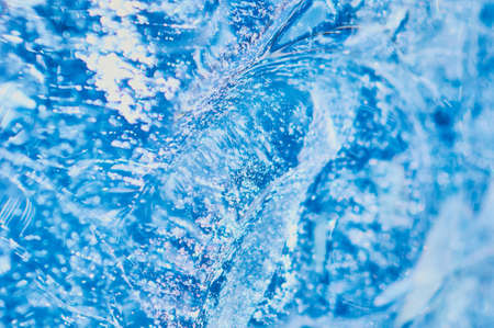 Texture background of pure natural water concept. selective focus. Wave, whirlpool and splash. Place to insert an inscription or logo.の写真素材