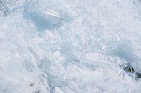 Ice drift on the Amur River. Melting ice floes in spring. A heap of blocks and fragments. Sunny day. Glare and shadows.の写真素材