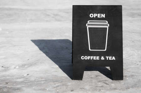 Cafe billboard on the street of Blagoveshchensk, Russia. The inscription is open, tea, coffee. winter season. Rolled snow surface. copyspace.の写真素材