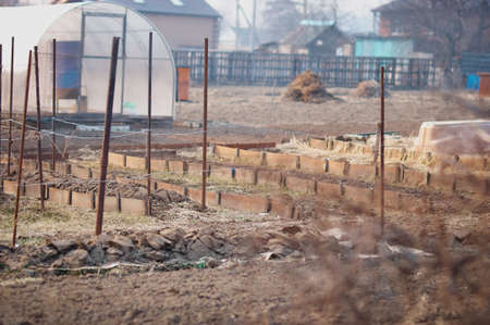 Prepared beds for planting crops. Small family garden. early spring. Selective focus on the middle plan.の写真素材