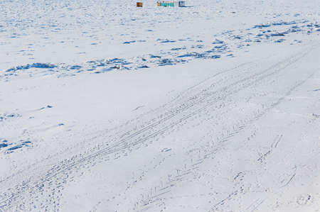 Amur river in winter. ice and snow. Ski track. Traces of animals and snowmobiles. Winter abstract background. Figure from skating. Sunny day. view from above. Blagoveshchensk, Russia.の写真素材