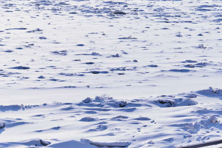 Snowdrifts on the ice of the Amur River. Morning after snowfall. The pattern of the shape of the...