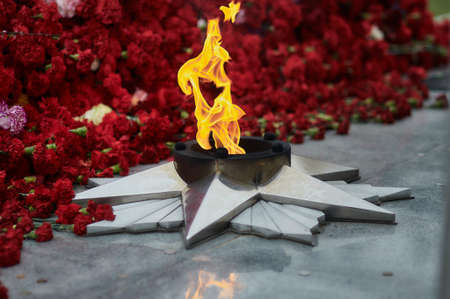 The flame of the eternal flame of the monument of the Second World War. A symbol of the solemn memory of the people about the fallen heroes. May 9 Victory Day. selective focusの写真素材