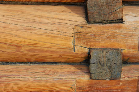 Texture of natural wood close up. New log house. Yellow lacquered wood. The outer surface of a rural residential building. Ecology concept. old technology.の写真素材
