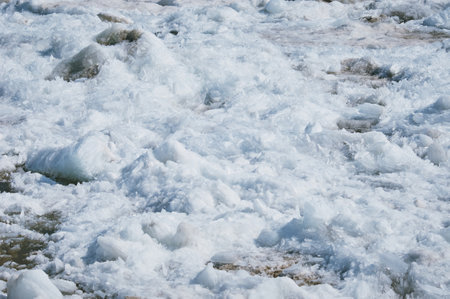 Ice on the river in spring on a sunny day. Texture from fragments of ice floes.の写真素材