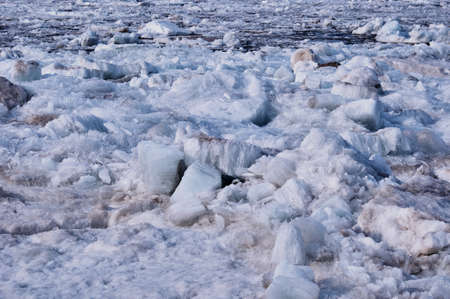 Melting river ice. Columnar and needle-like structure of crystals. Ice floe in the spring on the banks of the Amur River. Close view. Large blocks of solid water. Selective focus.の写真素材