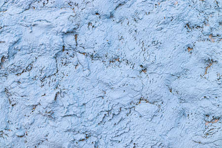 Sky-blue plaster on the wall with an uneven surface.の写真素材