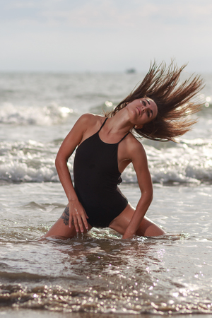 Beautiful young woman relaxing on the beachの写真素材
