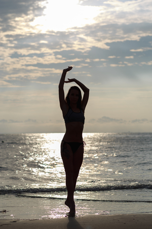 Beautiful young woman relaxing on the beachの写真素材