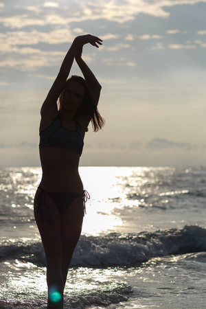Beautiful young woman relaxing on the beachの写真素材