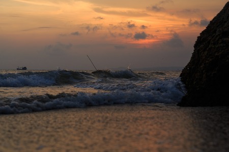 fishing boat to the sea at sunsetの写真素材