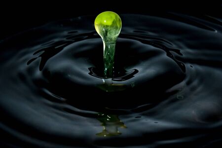 water drop splash in a glass, black backgroundsの写真素材