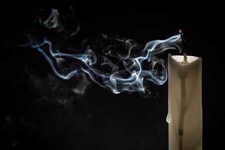 Smoke and extinct candle on a black backgroundの販売画像