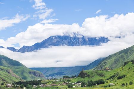 Amazing mountain landscape in Georgia on sunny summer day. Alpine green meadow in Caucasus...