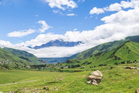 Amazing mountain landscape in Georgia on sunny summer day. Alpine green meadow in Caucasus...