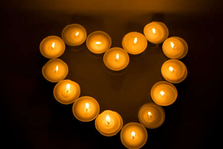 candle heart in the dark and black backgroundの写真素材