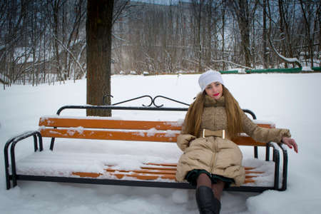 the girl on the bench in the winter oneの写真素材