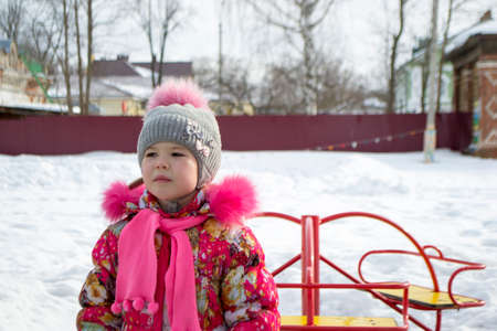 sad little girl on winter Playgroundの写真素材