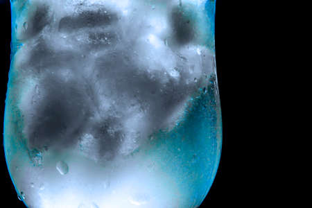 ice with water on a black background with water drops