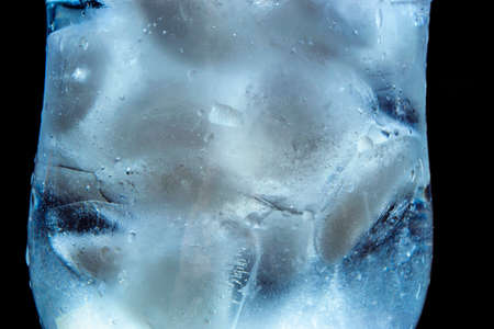 ice with water on a black background with water dropsの写真素材