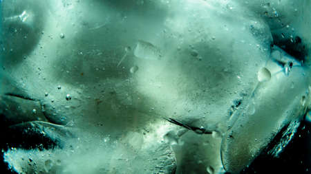 ice with water on a black background with water dropsの写真素材