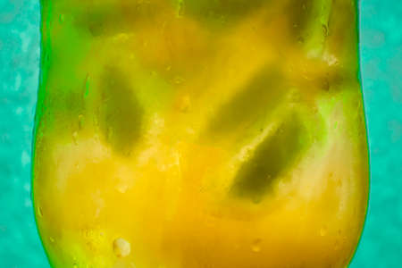 cold, refreshing yellow drink with iceの写真素材