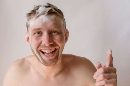 a man washes his head with shampoo