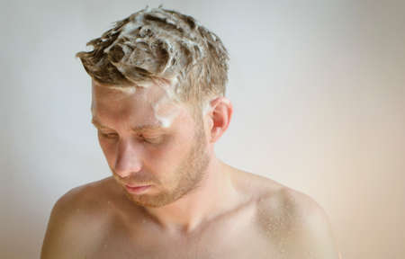 a man washes his head with shampooの写真素材
