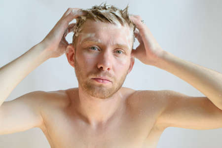 a man washes his head with shampooの写真素材