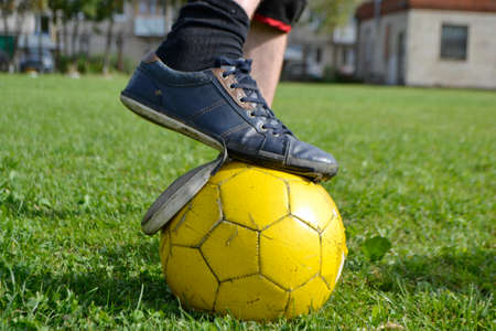 Ragged sneakers with a soccer ballの写真素材