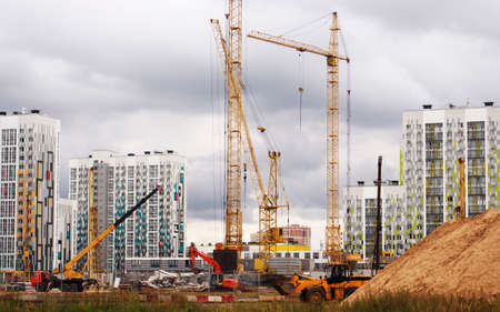 A construction site in Moscow, a lot of cranes and a concrete cut from the blue sky.の写真素材