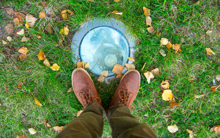 Feet Man walking on fall leaves Outdoor with Autumn season nature on background Lifestyle Fashion trendy style.の写真素材