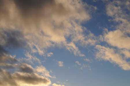 White and gray fluffy clouds on the blue sky.