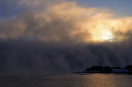 Large clouds in the sky above the water. Cold northern nature, the city of Murmansk. Cold autumn...