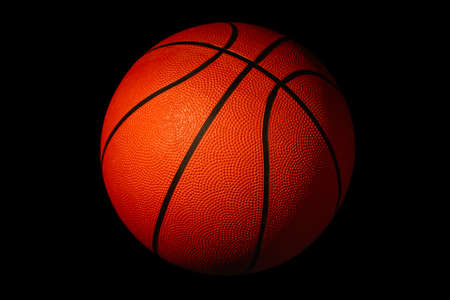 Basketball isolated on a black background as a sports and fitness symbolの写真素材
