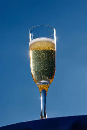 A glass of champagne on blue sky background. High quality photoの写真素材