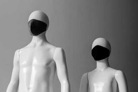 Two masked mannequins look to the future. Father and son during the epidemicの写真素材