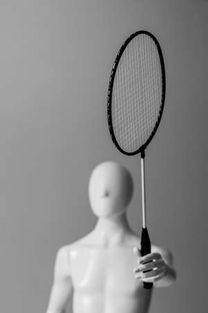 Mannequin plays tennis on a gray backgroundの写真素材